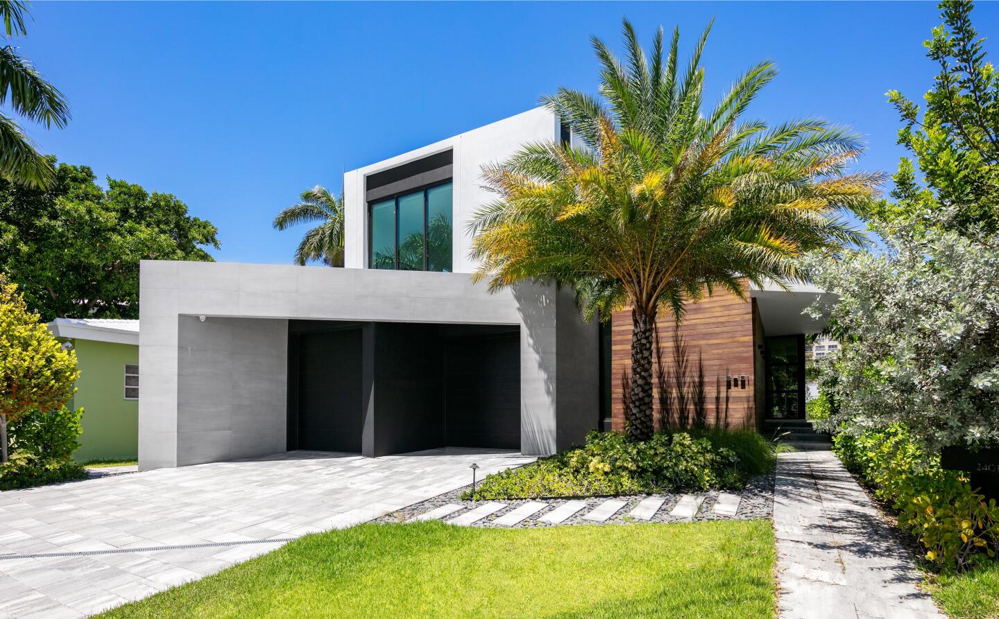 Set on Sunset Lake, the modern home built in 2019 includes a movie theater, swimming pool and private concrete dock.