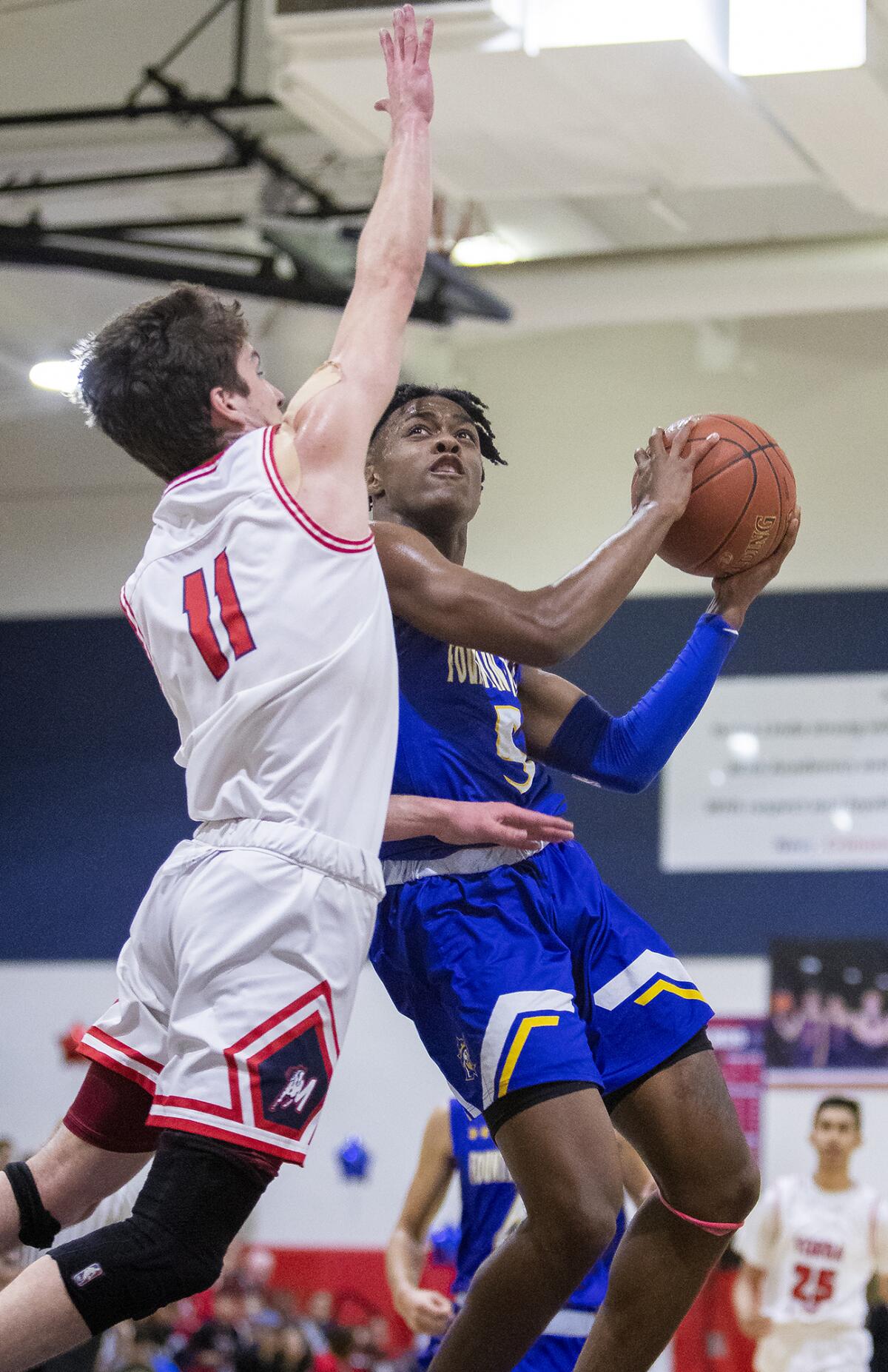 Fountain Valley's Jeremiah Davis, shown going for a shot in a Feb. 18 game against Yorba Linda, led the Barons past Gardena 66-63 in a CIF State Southern California Regional Division III playoff opener on Tuesday.