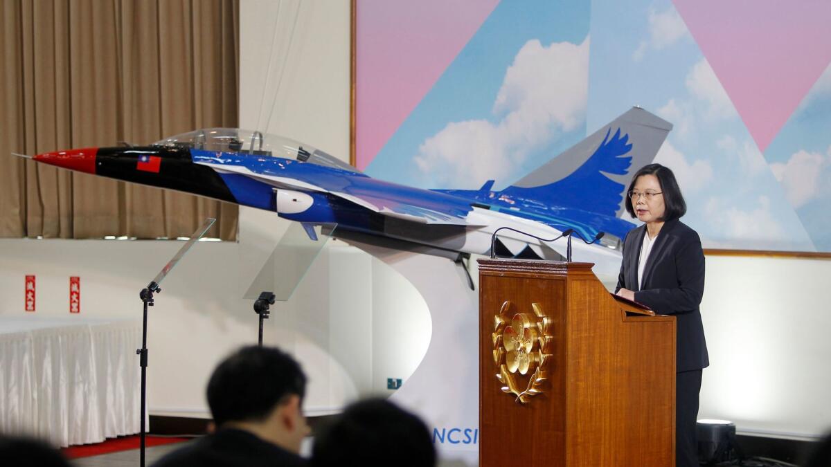 Taiwan's President Tsai Ing-wen speaks in front of a model of a Taiwan-made jet Dec. 29 at the National Chung-Shan Institute of Science & Technology in Taoyuan county.
