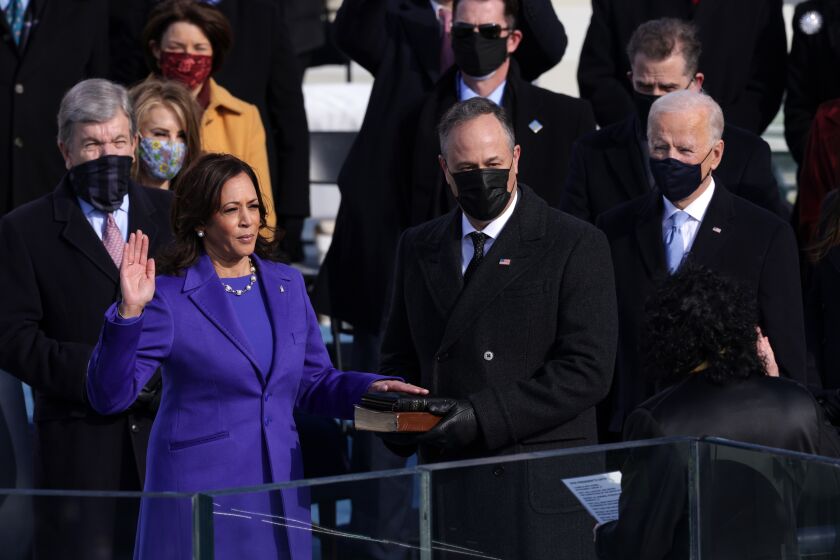 WASHINGTON, DC - JANUARY 20: Kamala Harris is sworn in as Vice President of the United States as her husband Doug Emhoff looks on during the inauguration of U.S. President-elect Joe Biden on the West Front of the U.S. Capitol on January 20, 2021 in Washington, DC. During today's inauguration ceremony Joe Biden becomes the 46th president of the United States. (Photo by Alex Wong/Getty Images)
