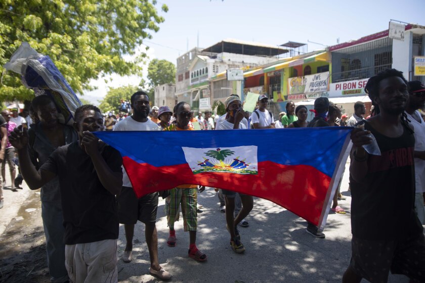 Demonstrators march demanding peace and security in La Plaine neighborhood of Port-au-Prince, Haiti, Friday, May 6, 2022. (AP Photo/Odelyn Joseph)