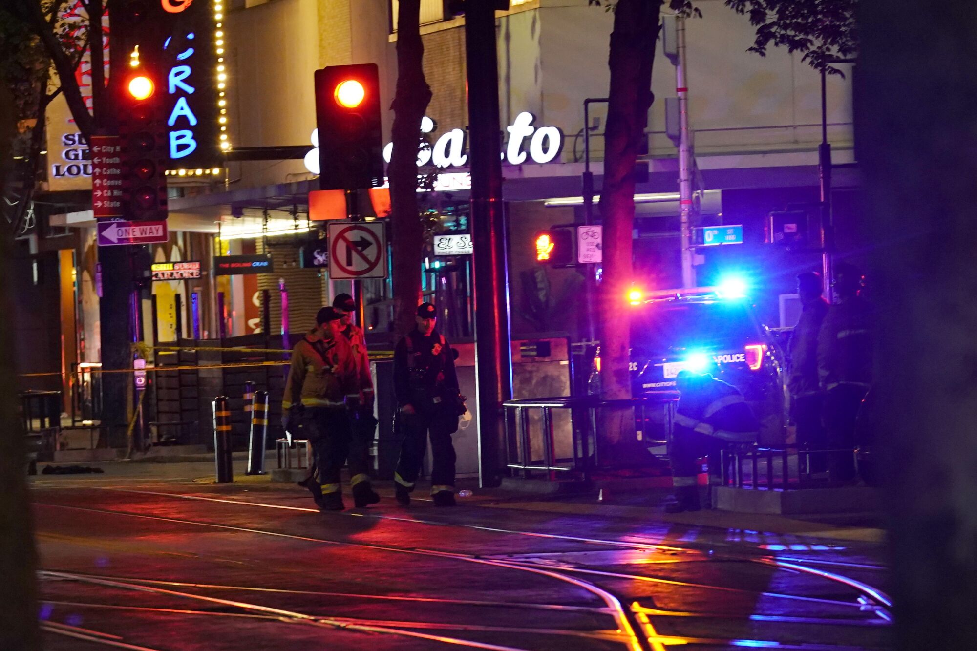 First responders walk near the scene of Sunday's mass shooting