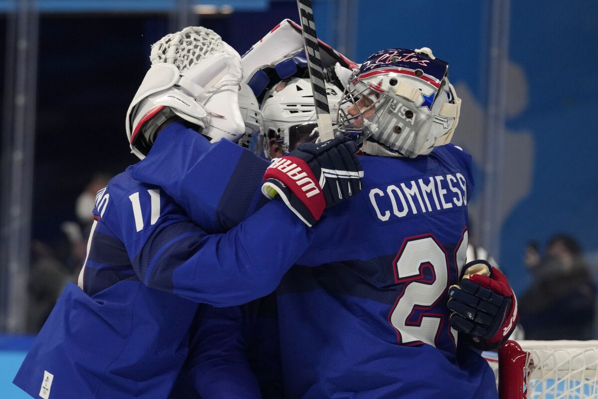 United States celebrates a win over Germany in a preliminary round men's hockey game at the 2022 Winter Olympics, Sunday, Feb. 13, 2022, in Beijing. (AP Photo/Petr David Josek)