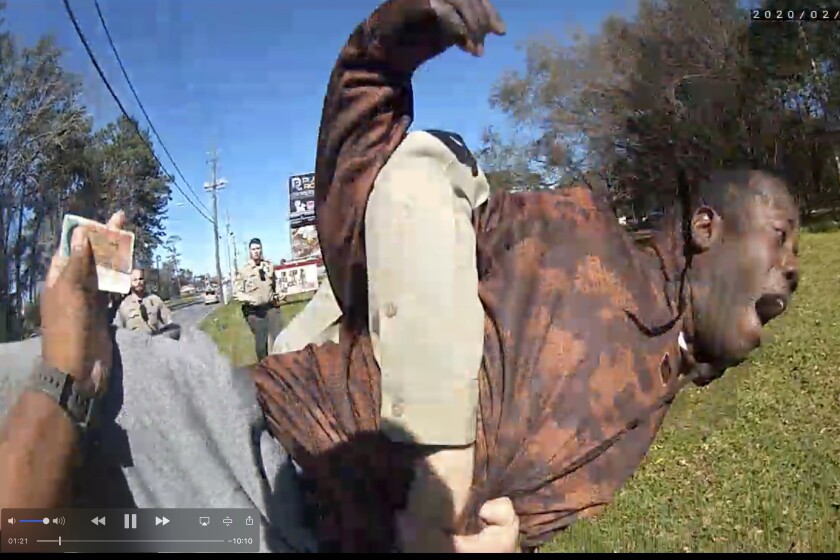 In this still image from body camera video released by the Valdosta police, Antonio Arnelo Smith is slammed face-first to the ground by a Valdosta police sergeant, in Valdosta, Ga., on Feb. 8, 2020. The video shows Smith handing his driver's license to a police officer and answering questions cooperatively before a second officer, Sgt. Billy Wheeler, approaches him from behind, wraps him in a bear hug and slams him face-first to the ground. Smith is crying in pain when he's told there's a warrant for his arrest. Officers are then told the warrant was for someone else. (Valdosta Police via AP)