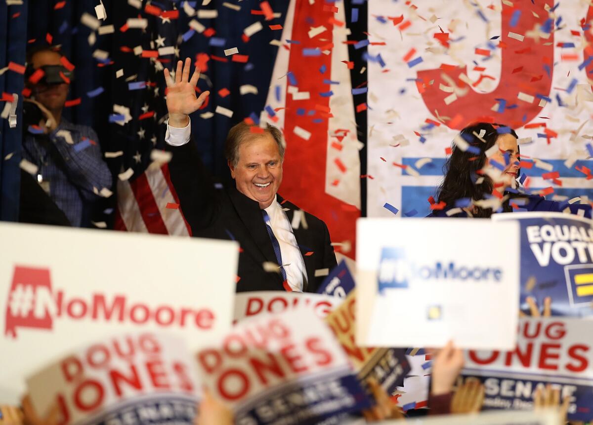 Democrat Doug Jones celebrates with supporters in Birmingham, Ala., after he was declared the winner over Roy Moore.
