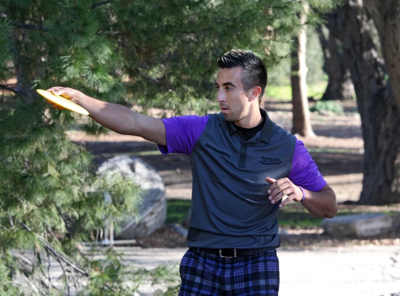 Four-time consecutive world disc golf champion Paul McBeth prepares to take his first throw at the 38th Annual Professional Disc Golf Assn. Wintertime Open at Hahamongna Watershed Park in Pasadena on Saturday, Feb. 20, 2016.