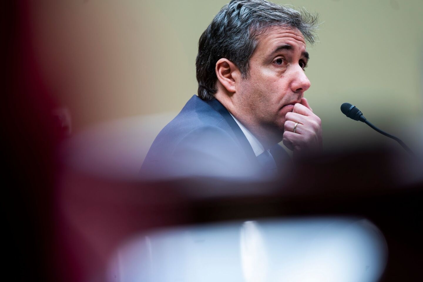 Michael Cohen listens to questions before the House Oversight and Reform Committee on Capitol Hill.
