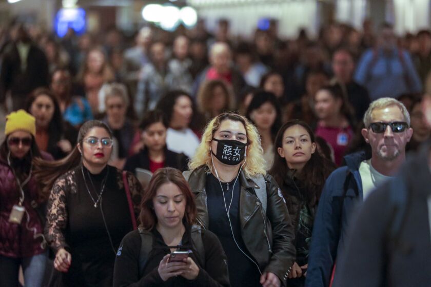 LOS ANGELES, CA - JANUARY 31, 2020 - Some commuters at Union Station adorn breathing masks. (Irfan Khan / Los Angeles Times)