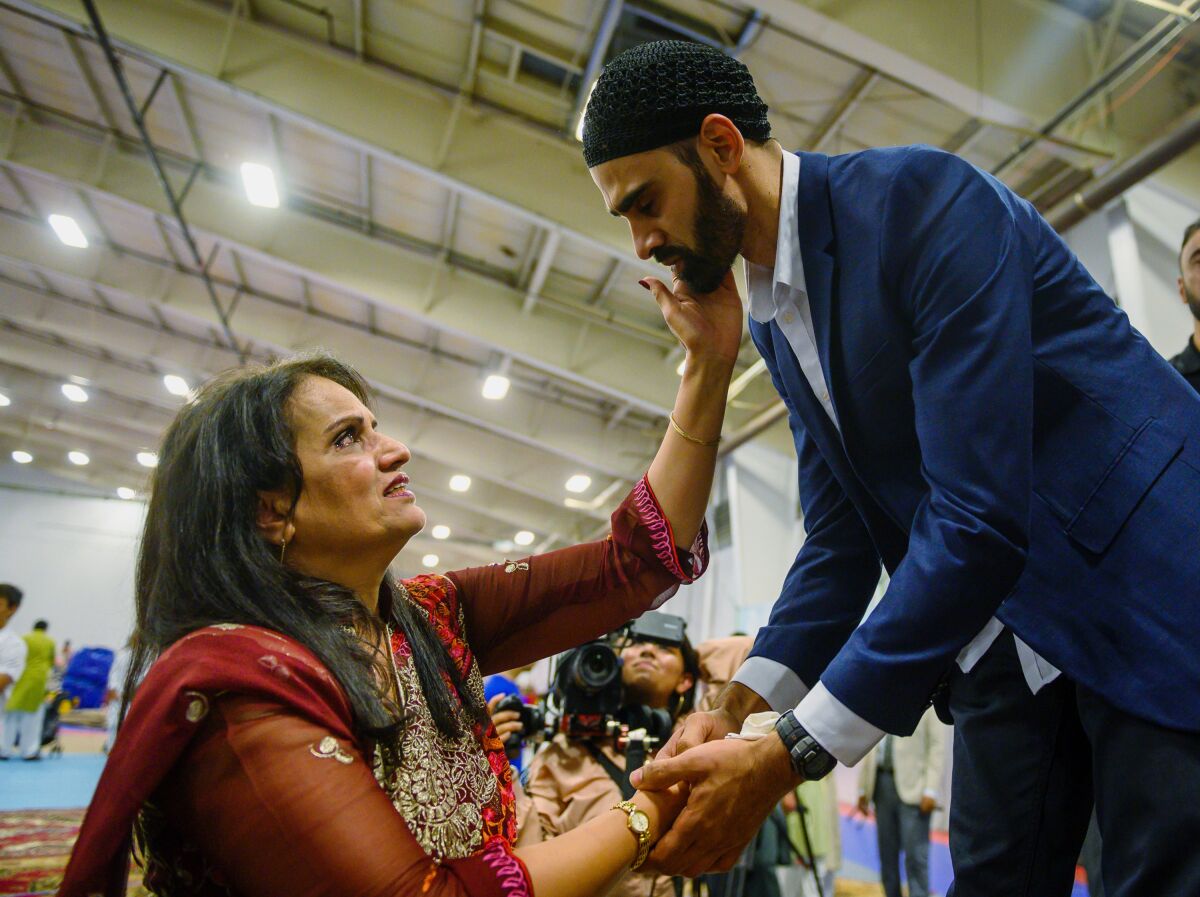 FILE - In this Aug. 11, 2019, file photo, Hamid Hayat, right, is welcomed by the community after making his first public appearance at a news conference that coincided with Eid al-Adha, also called the "Festival of the Sacrifice," an Islamic holiday, in Sacramento, Calif. Federal prosecutors in California on Friday, Feb. 14, 2020, ended what once was among the nation's highest profile anti-terrorism cases, after a judge earlier overturned Hayat's conviction that grew from conspiracy allegations in the wake of the 2001 terrorist attacks. (Daniel Kim/The Sacramento Bee via AP, File)