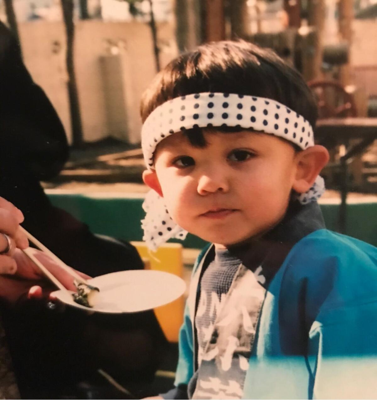 USC football player Brett Neilon, shown as a child, looks at the camera