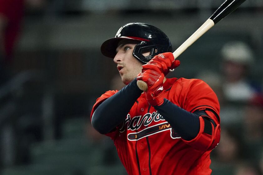 Atlanta Braves' Austin Riley watches his solo home run during the second inning of the team's baseball game against the New York Mets on Friday, Sept. 30, 2022, in Atlanta. (AP Photo/John Bazemore)