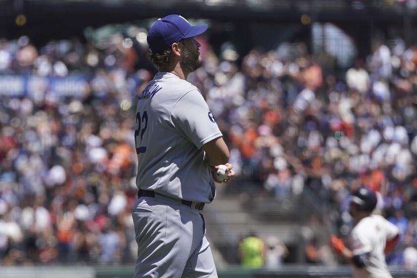 Los Angeles Dodgers pitcher Clayton Kershaw, foreground, reacts.