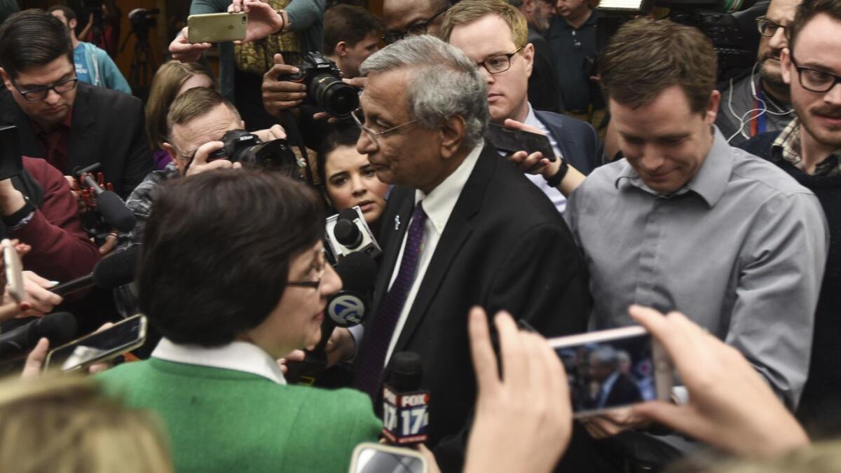 Members of the media gather around newly named Michigan State University interim president Satish Upta following a board of trustees meeting on Jan. 17.