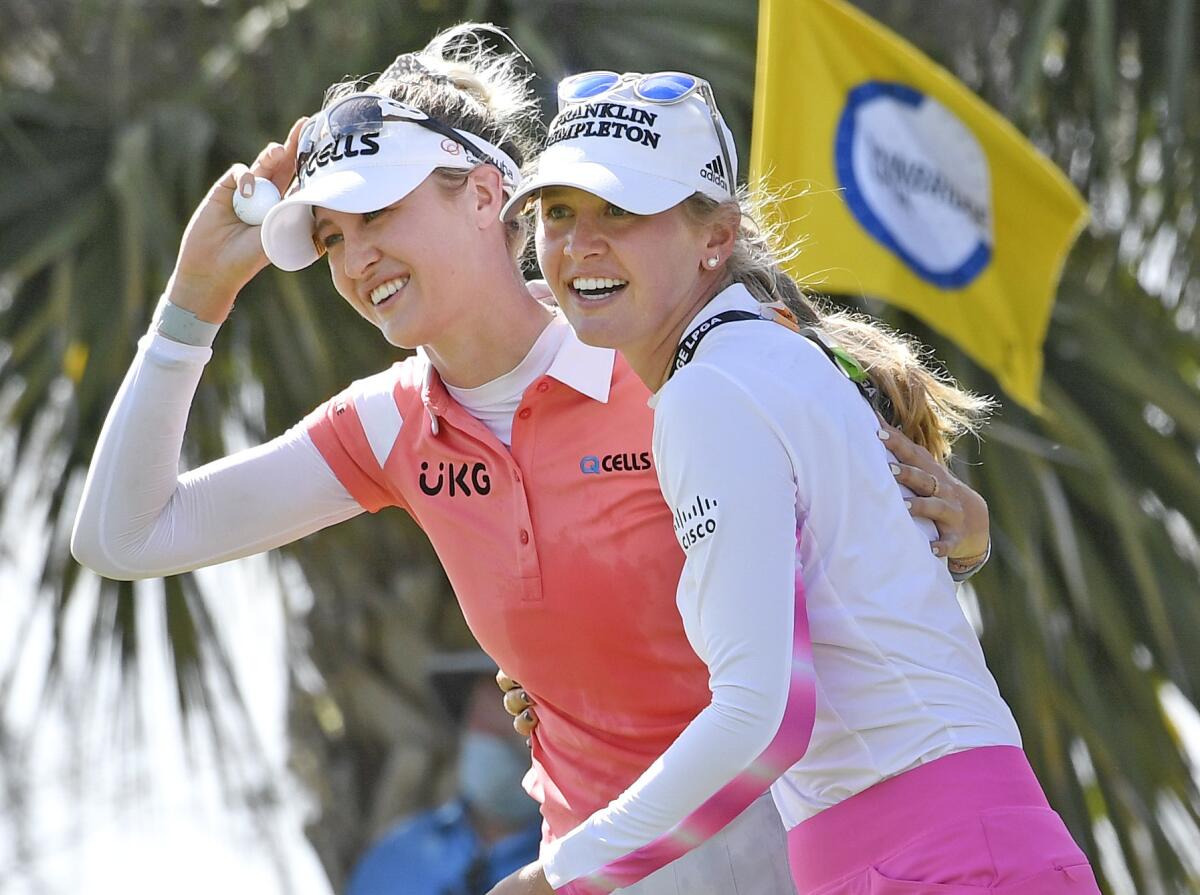 Nelly Korda, left, celebrates with her sister Jennifer, right, walking off the 18th green.