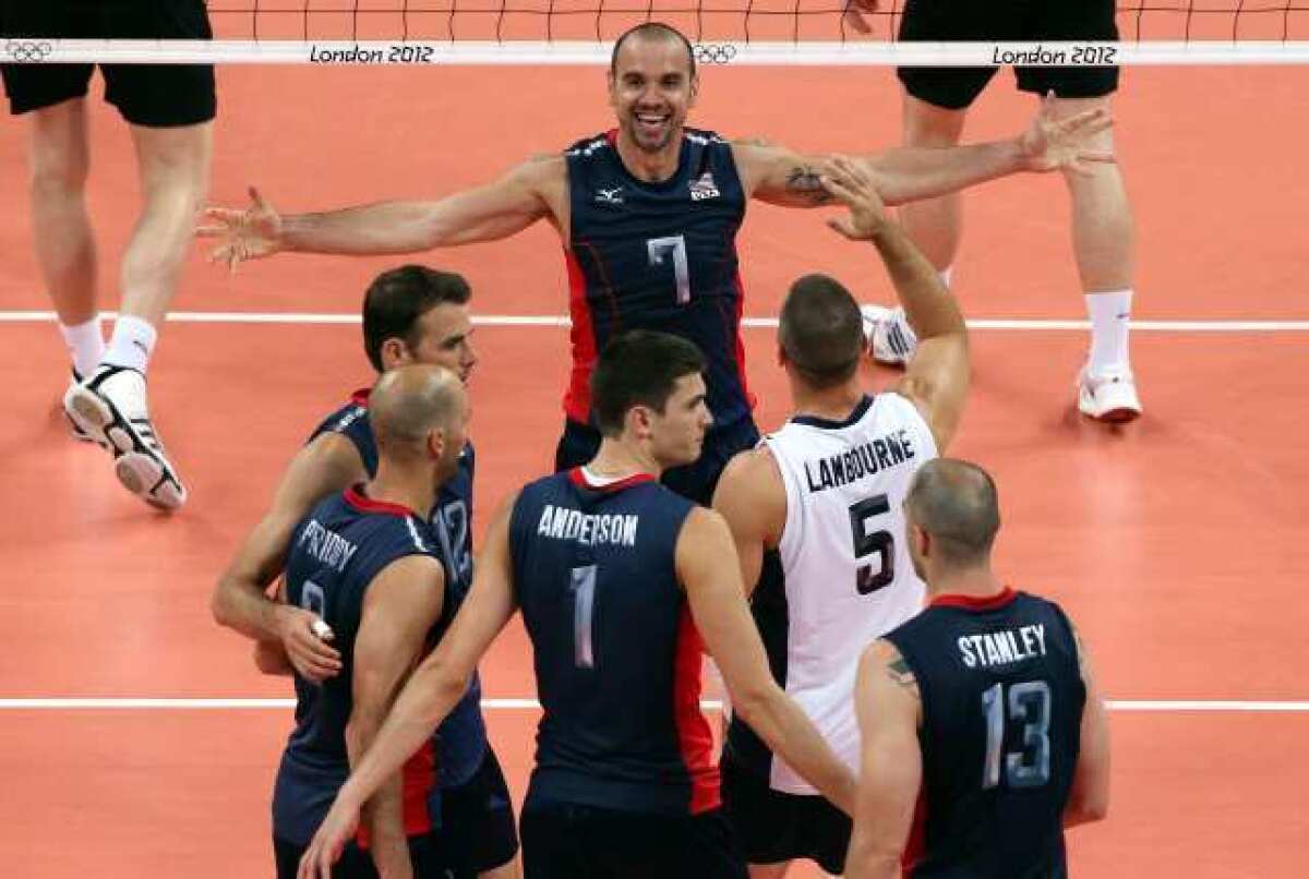 Members of the men's U.S. Olympic volleyball team celebrate their victory over Germany.
