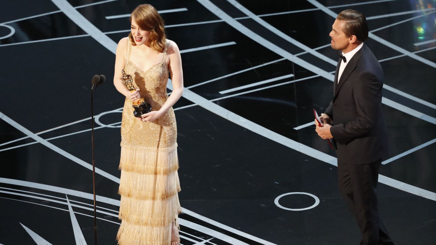 "La La Land" star Emma Stone on stage with Leonardo DiCaprio after she won the Oscar for lead actress.