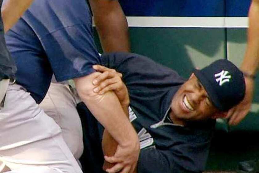 New York Yankees' Mariano Rivera grimaces after twisting his right knee shagging fly balls during batting practice on Thursday evening.