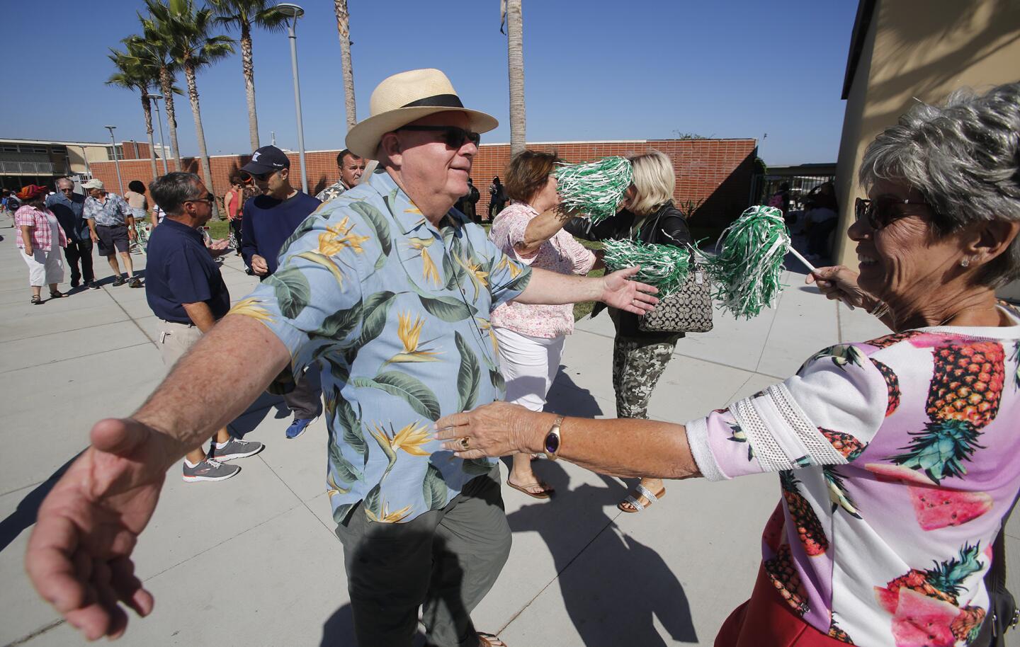 Rusty Lusk and Shirley Macy embrace after having not seen each other in years as members of the class of 1968 gather at Costa Mesa High School on Friday before their 50th-anniversary reunion Saturday.