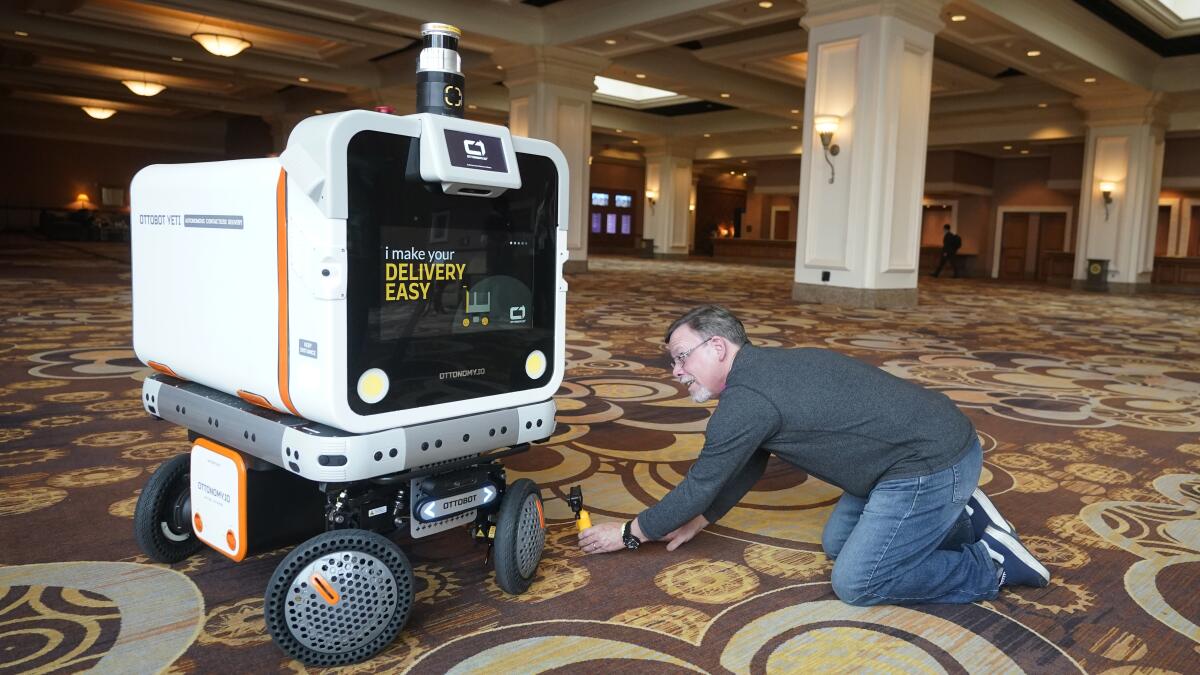 A man films a delivery robot