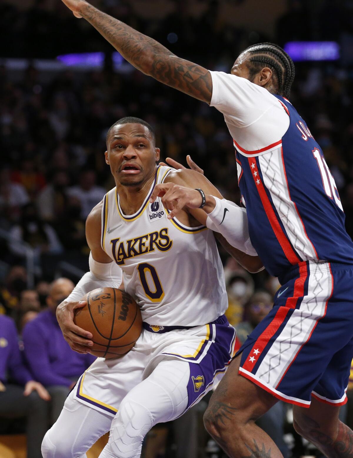 Lakers guard Russell Westbrook guarded by Brooklyn Nets forward James Johnson.
