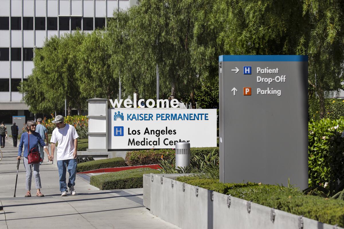 People walk past a "Welcome" sign at Kaiser's Los Angeles hospital.