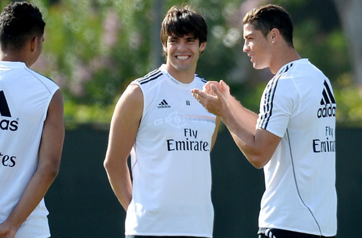 Cristiano Ronaldo, right, talks to Real Madrid teammates Kaka, center, and Carlos Henrique Casimiro during a training session at UCLA on Friday.