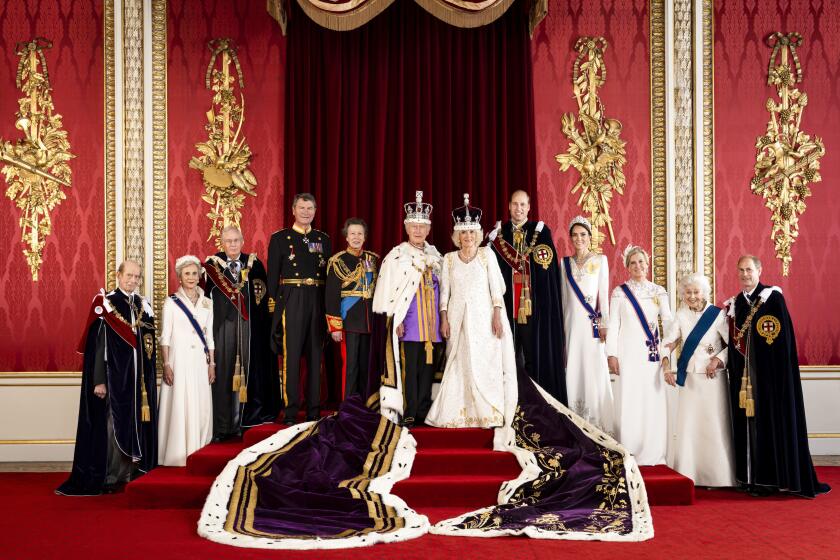 In this photo made available by Buckingham Palace on Monday, May 8, 2023, Britain's King Charles III and Queen Camilla are pictured with members of the working royal family, from left Prince Edward, the Duke of Kent, Birgitte, Duchess of Gloucester, Prince Richard, the Duke of Gloucester, Vice Admiral Sir Tim Laurence, Princess Anne, Prince William, the Prince of Wales, Kate, the Princess of Wales, Sophie, the Duchess of Edinburgh, Princess Alexandra, the Hon. Lady Ogilvy and Prince Edward, the Duke of Edinburgh, in the Throne Room at Buckingham Palace, London. (Hugo Burnand/Royal Household 2023 via AP)