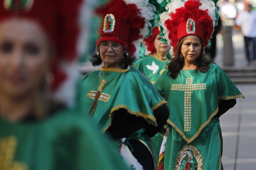 Violeta Murillo of Our Lady of Guadeloupe in Chula Vista dances during the Procession to Honor Our Lady of Guadalupe in downtown San Diego on Dec. 1, 2019.
