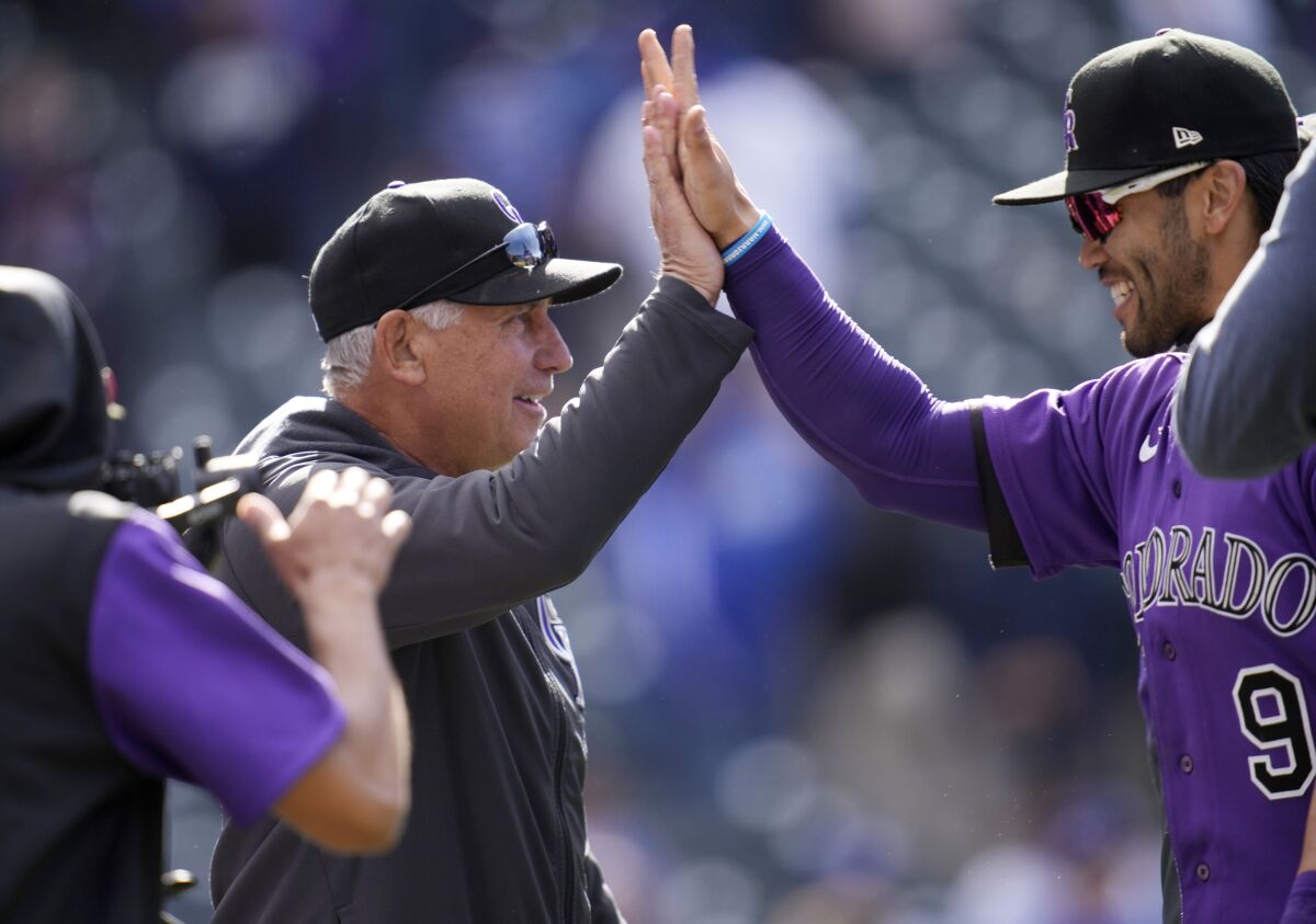 Colorado Rockies manager Bud Black, left, congratulates first baseman Connor Joe after the ninth inning of a baseball game against the Los Angeles Dodgers Sunday, April 10, 2022, in Denver. (AP Photo/David Zalubowski)