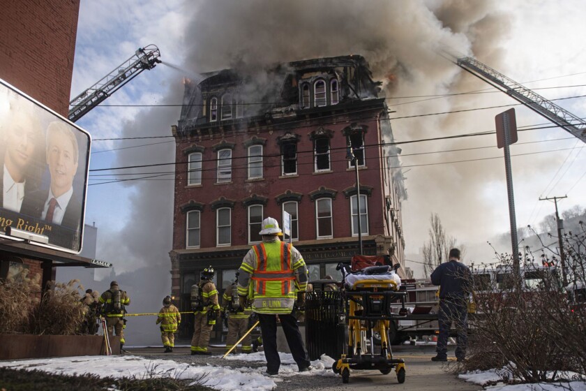 FILE — Crews battle a four-alarm fire in Pittsburgh, Pa., Feb. 8, 2021. As smoke poured through a New York City high-rise Sunday, Jan.9. 2022, killing several people, tenants in the building were faced with life or death decisions about what to do to escape the blaze.(Nate Smallwood/Pittsburgh Tribune-Review via AP, File)