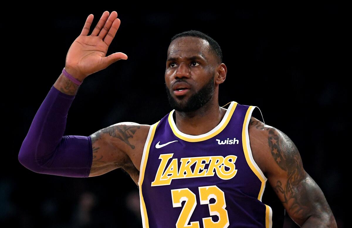 Lakers star LeBron James celebrates after dunking on the Golden State Warriors during a 120-94 win Wednesday at Staples Center.