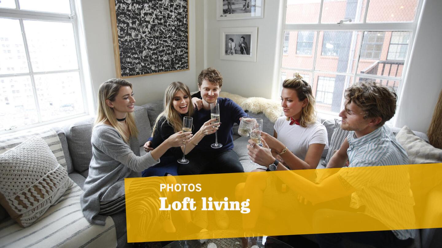 Kicking back in the downtown L.A. loft are, from left, interior designer Joyce Pickens of JDP Interiors, homeowners Carlson Young and Isom Innis, interior designer Caroline Walkup and Foster the People's Mark Pontius.