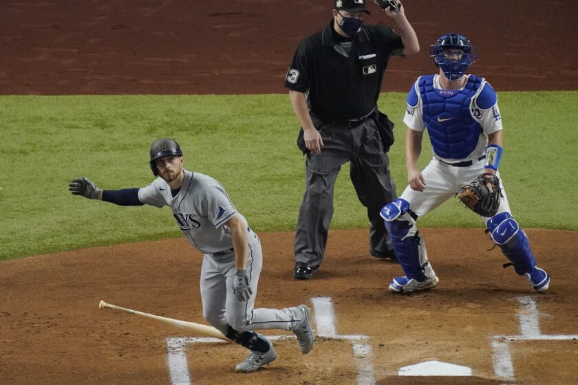 Tampa Bay Rays' Brandon Lowe watches his home run against the Los Angeles Dodgers during the first inning in Game 2 of the baseball World Series Wednesday, Oct. 21, 2020, in Arlington, Texas. (AP Photo/Sue Ogrocki)