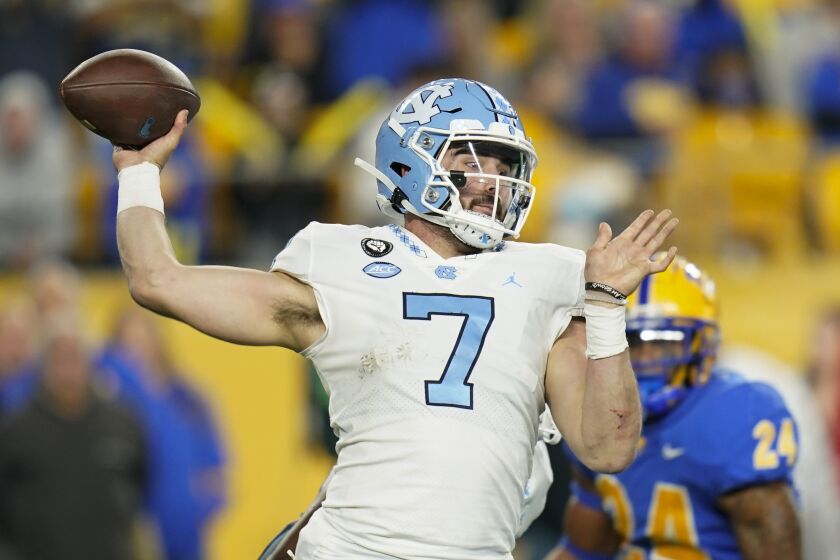 North Carolina quarterback Sam Howell (7) throws a pass as Pittsburgh linebacker Phil Campbell III rushes during the first half of an NCAA college football game Thursday, Nov. 11, 2021, in Pittsburgh. (AP Photo/Keith Srakocic)
