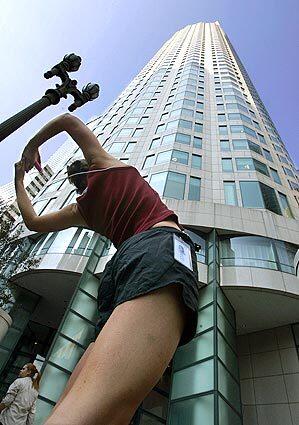 WARMING TO THE TASK:Lindsey Jurca, 24, who works at a law firm in the tower, stretches before ascending the floors with her three teammates. Individual competition takes place today.