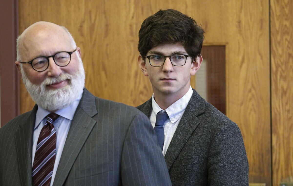 Looking in the direction of the accuser's family, former St. Paul's School student Owen Labrie, right, enters the courtroom with his defense attorney J.W. Carney for closing remarks in Labrie's rape trial at Merrimack Superior Court on Thursday in Concord, N.H.
