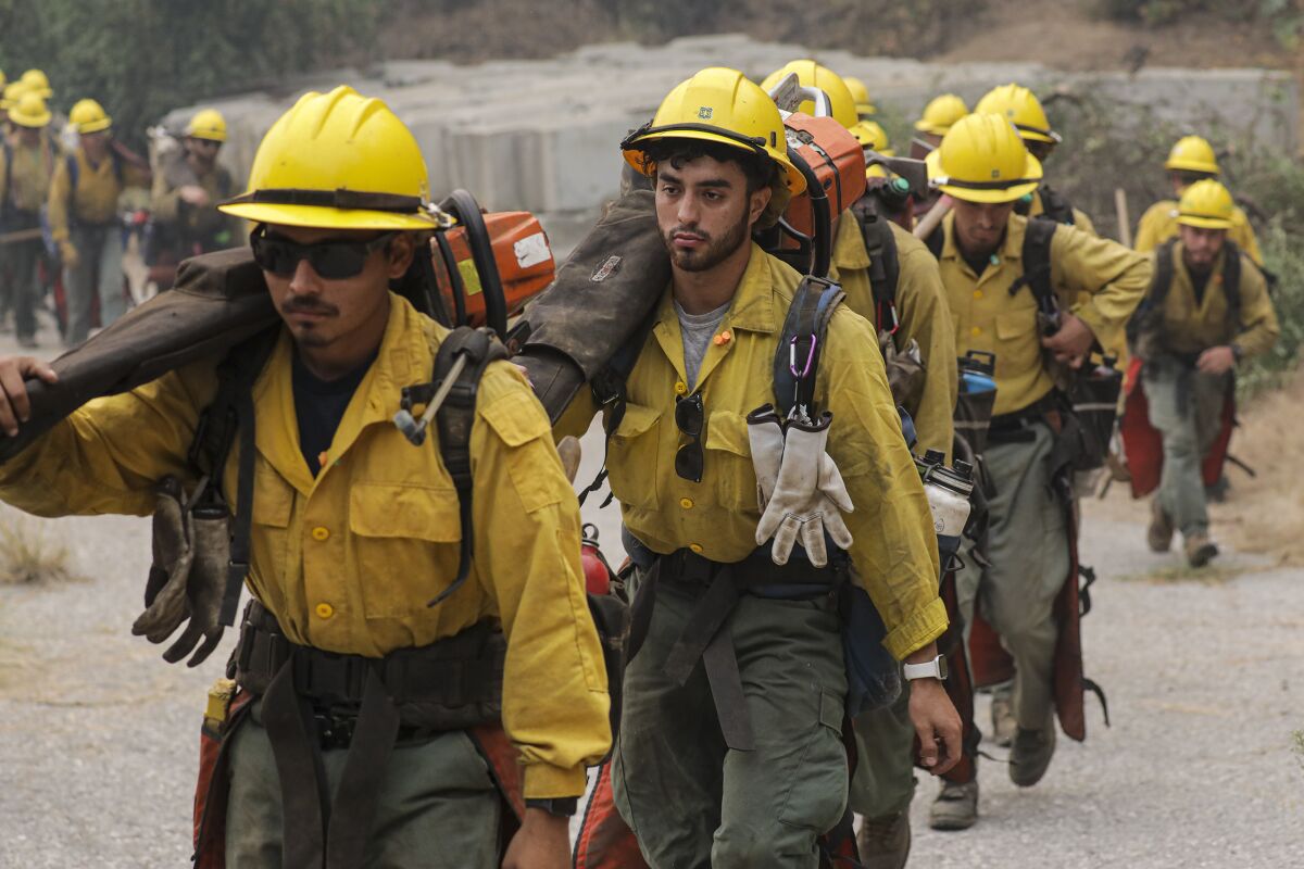 An Angeles National Forest fire crew heads into the forest to create a fire line. 