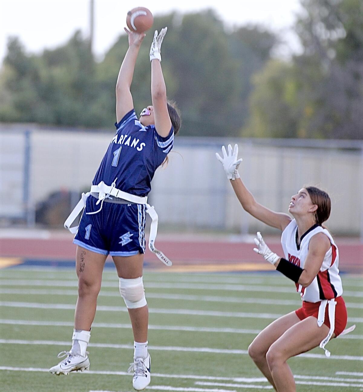Sylmar’s Mia Ceja makes a leaping catch in front of Verdugo Hills defensive back Lauren Brink in the Dons’ 29-20 victory.