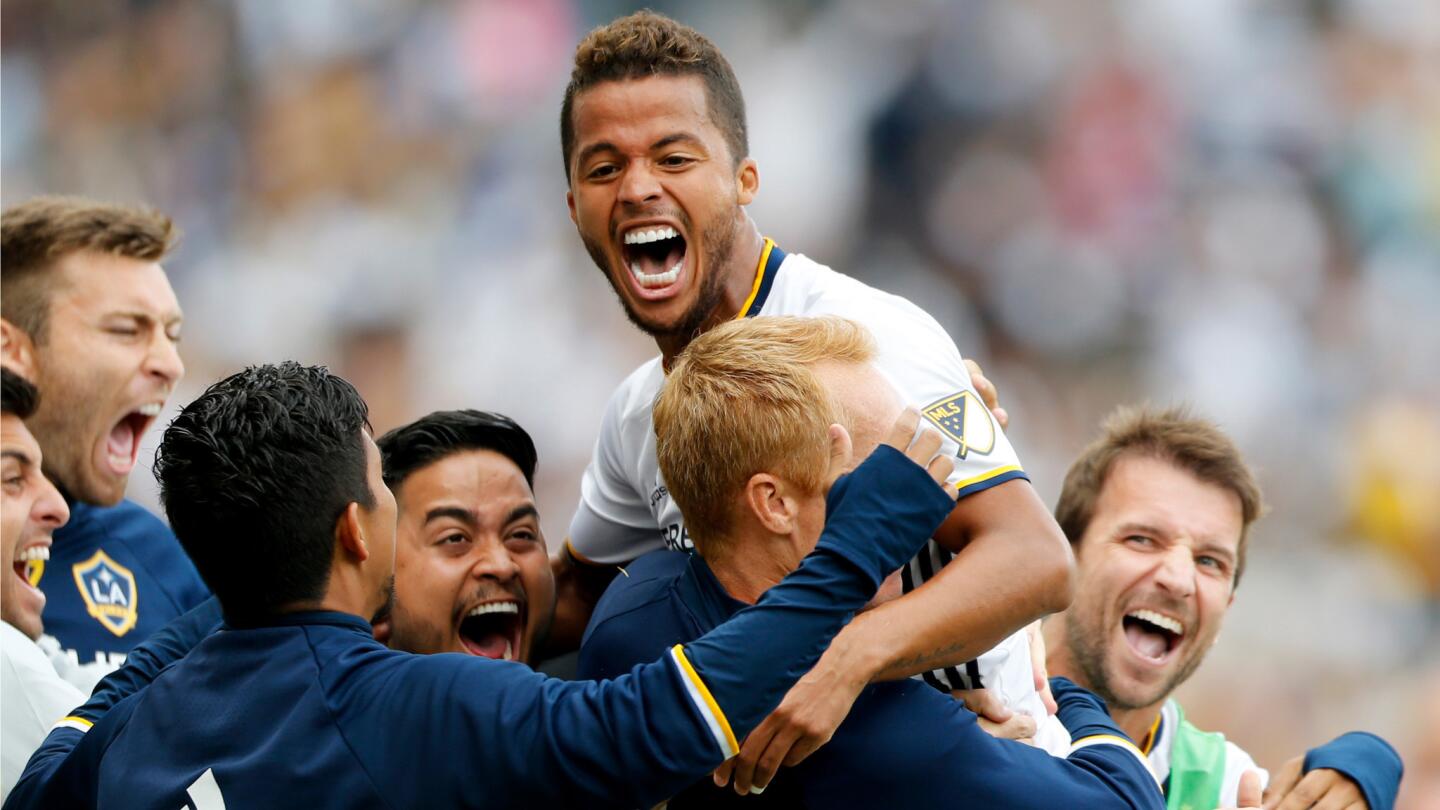 Galaxy forward Giovani dos Santos celebrates with teammates after scoring a goal against the Rapids.