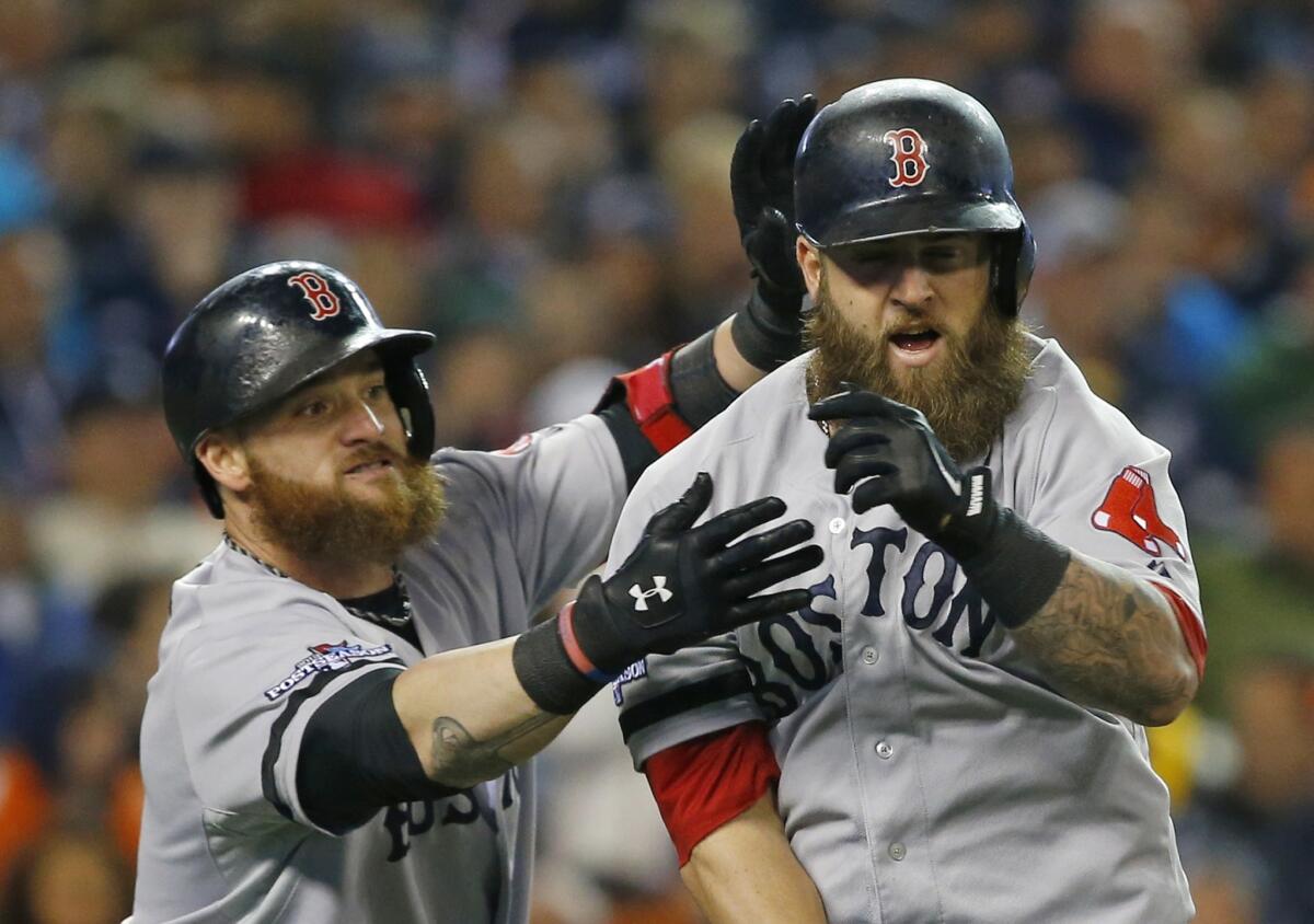 Boston's Mike Napoli, right, is congratulated by teammate Jonny Gomes after hitting a home run in Game 5 of the ALCS against the Detroit Tigers. The transformation of the Red Sox from a last-place team to a World Series-bound team has been a surprise -- at least to some.