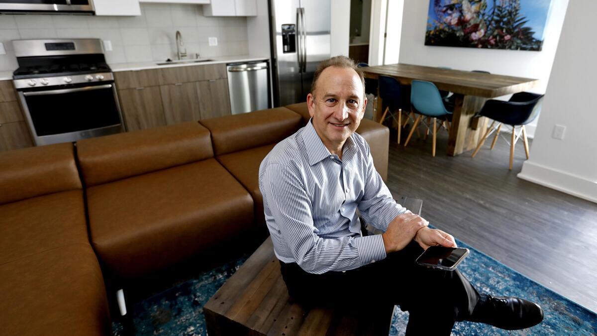 Ken Kahan, founder and president of California Landmark Group, sits in a common living area in a C1 co-living unit.