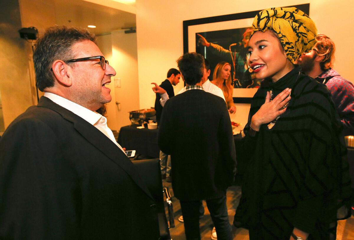 Lucian Grainge, chairman of Universal Music Group, greets Yuna, a 27-year-old pop singer from Malaysia, after she performed for a group of executives at the record company's Santa Monica headquarters in November.