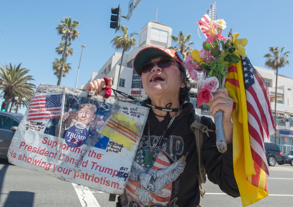 Victoria Cooper, 72, of Westminster, rallies in support of Donald Trump in Huntington Beach Saturday.