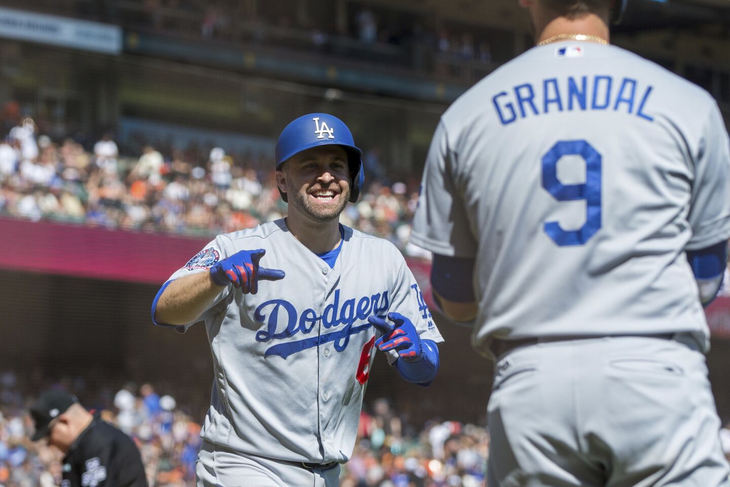 Los Angeles Dodgers Brian Dozier, left, celebrates with catcher Yasmani Grandal after he hit a two-run homer against the San Francisco Giants in the third inning of a baseball game in San Francisco, Sunday, Sept. 30, 2018.