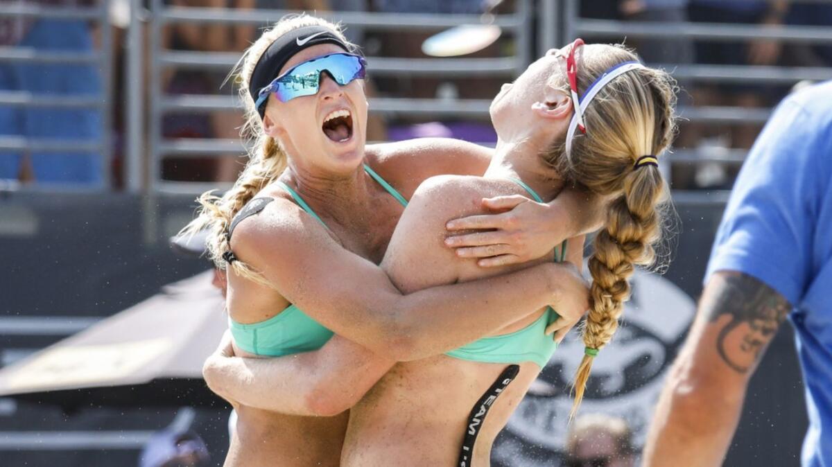 Sara Hughes, left, hugs partner Summer Ross after winning the 2018 Hermosa Beach Open.