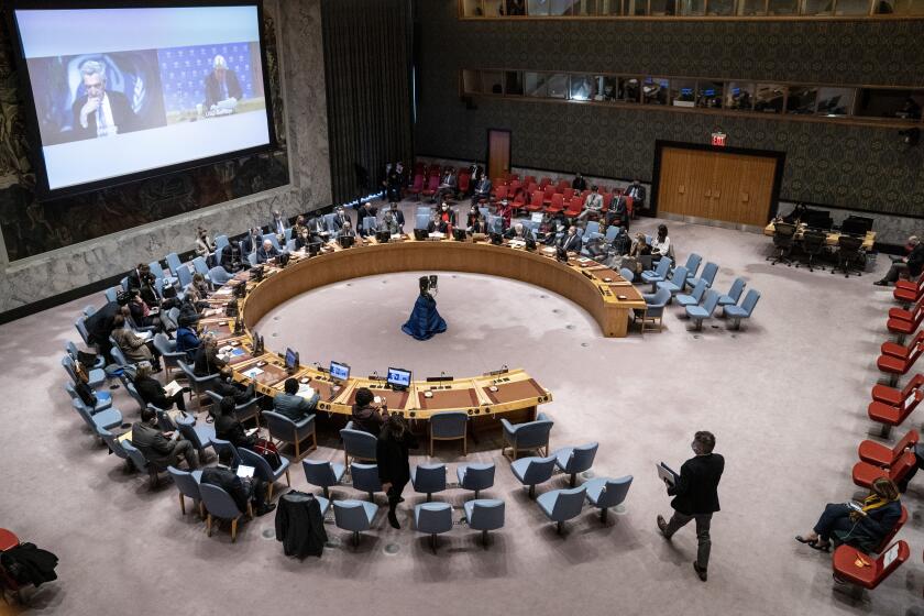 Sergiy Kyslytsya, permanent representative of Ukraine to the United Nations, bottom right, moves to take his seat during a meeting of the security council, Monday, Feb. 28, 2022, at United Nations headquarters. (AP Photo/John Minchillo)