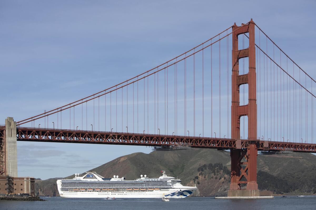 A cruise ship sails in under the Golden Gate Bridge to dock at the Port of Oakland.