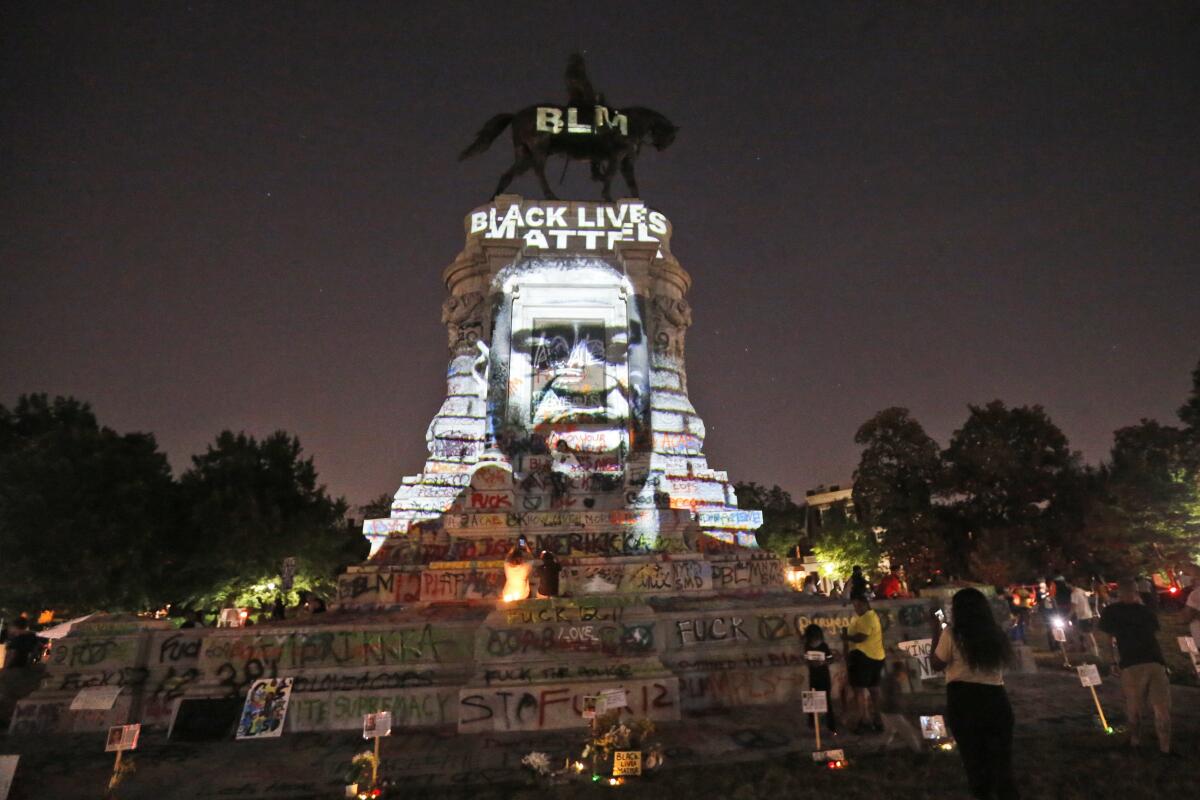 An image of George Floyd was projected on the base of the statue of Confederate Gen. Robert E. Lee in Richmond, Va.