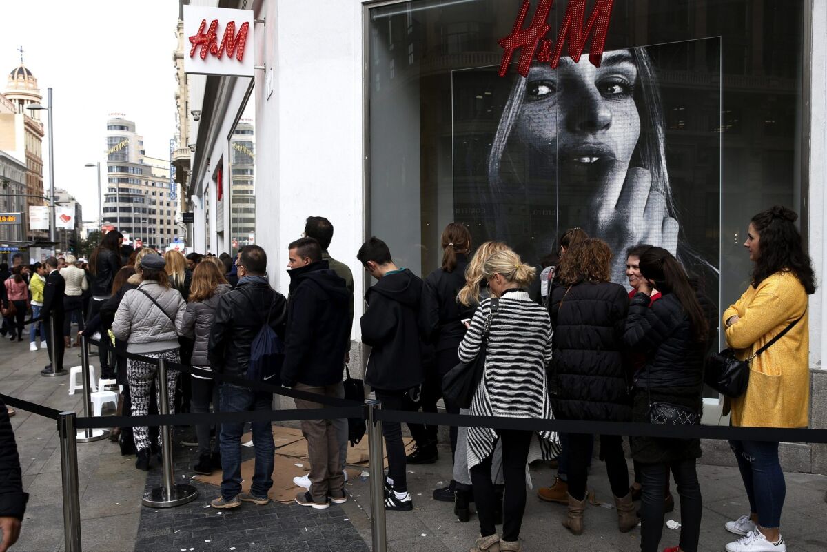 Customers line up outside an H&M store in Madrid on Nov. 5, 2015, the day the Swedish fast fashion company's collaboration with Balmain was released.