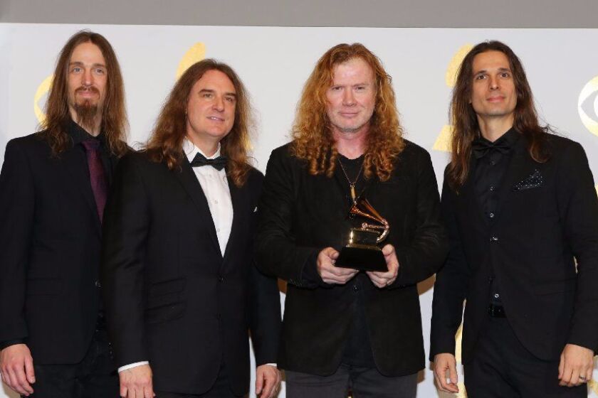 La Mesa native and Megadeth leader Dave Mustaine holds his band's first Grammy Award.